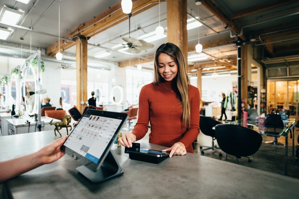 Shop owner at their counter reviewing payments